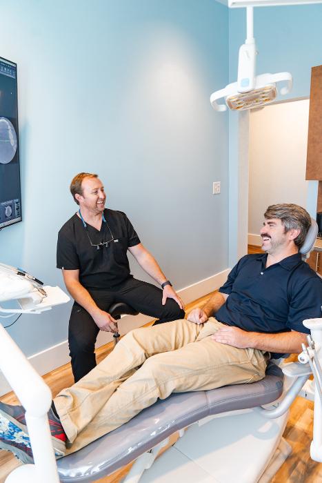 restorative dentist surf city | Dr. Parr with patient