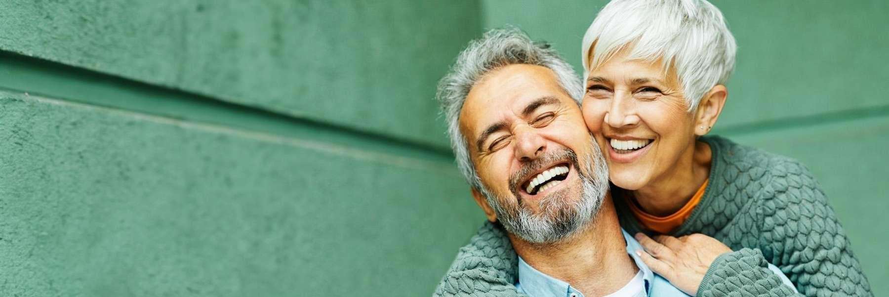hybrid dentures | couple smiling