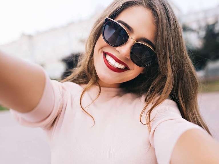 a woman taking a selfie in Surf City Dental 