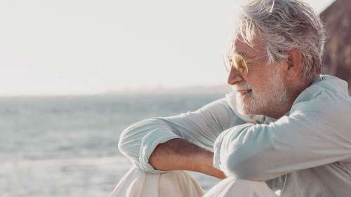 man sitting on the beach