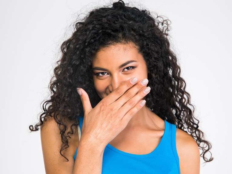 gum disease treatment hampstead | woman covering mouth