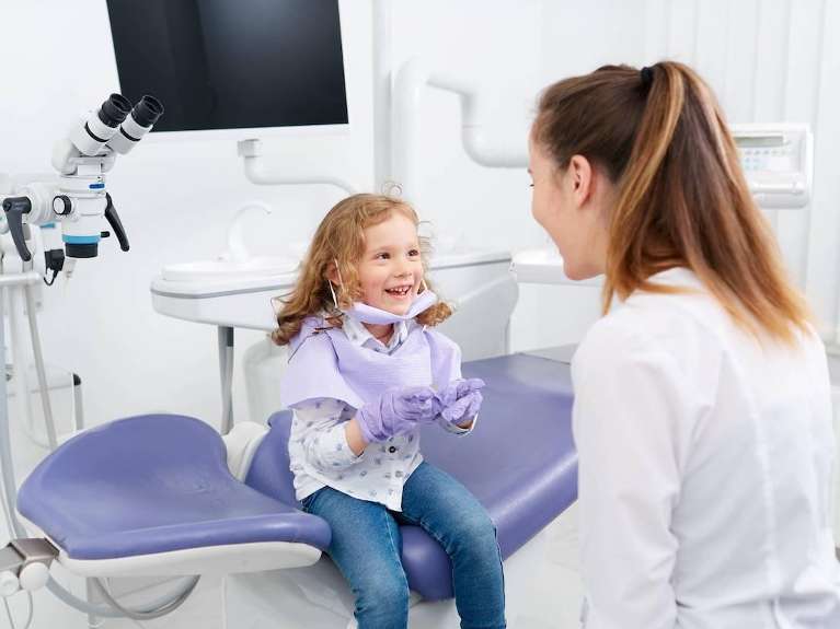 A dentist and a kid during a dentist visit in Surf City, NC