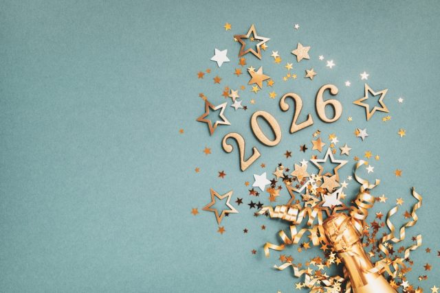 Champagne bottle with golden confetti and stars celebrating 2026, symbolizing New Year’s resolutions for dental health.