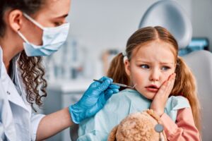 girl with tooth pain